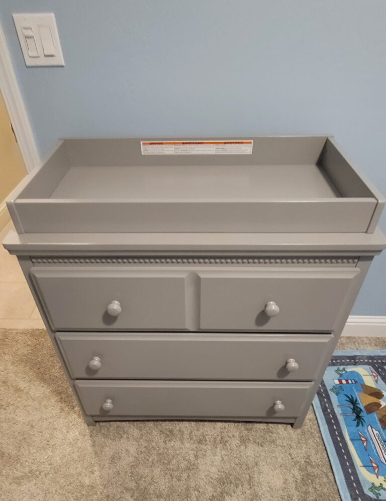 Assembled dark beige 3 drawer dresser with a baby changing station/enclosed pad on top. Assembly Service. Kern County, Bakersfield, CA, USA